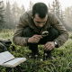 Botanist examining magic mushrooms in Canadian field