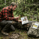 Forager examining wild mushrooms in Canadian forest