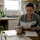 Woman learning about mushroom safety at kitchen table