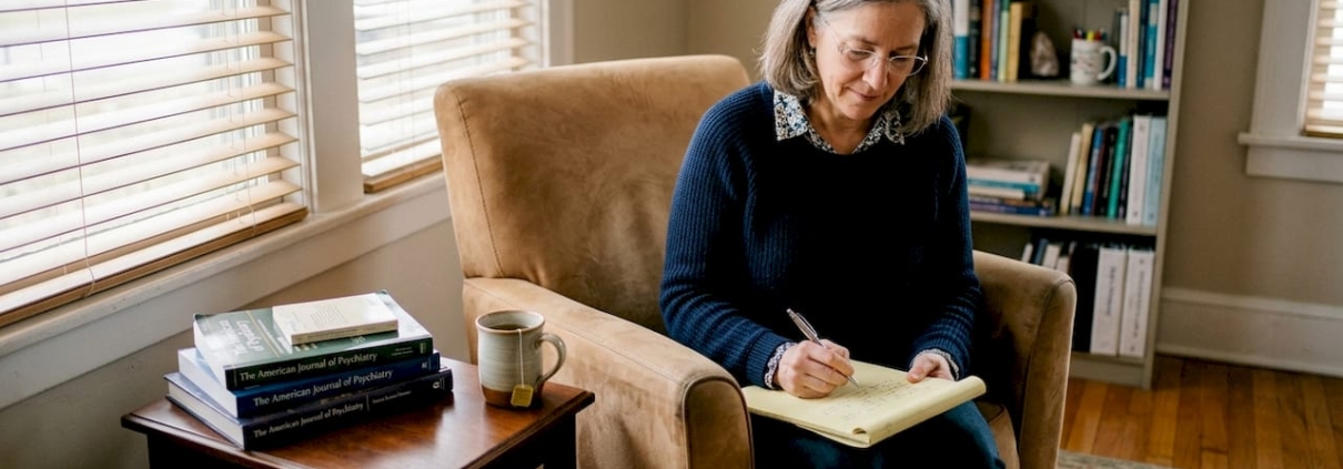 Therapist reviewing notes in cozy office