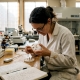 Researcher examining mycelium growth in lab dish