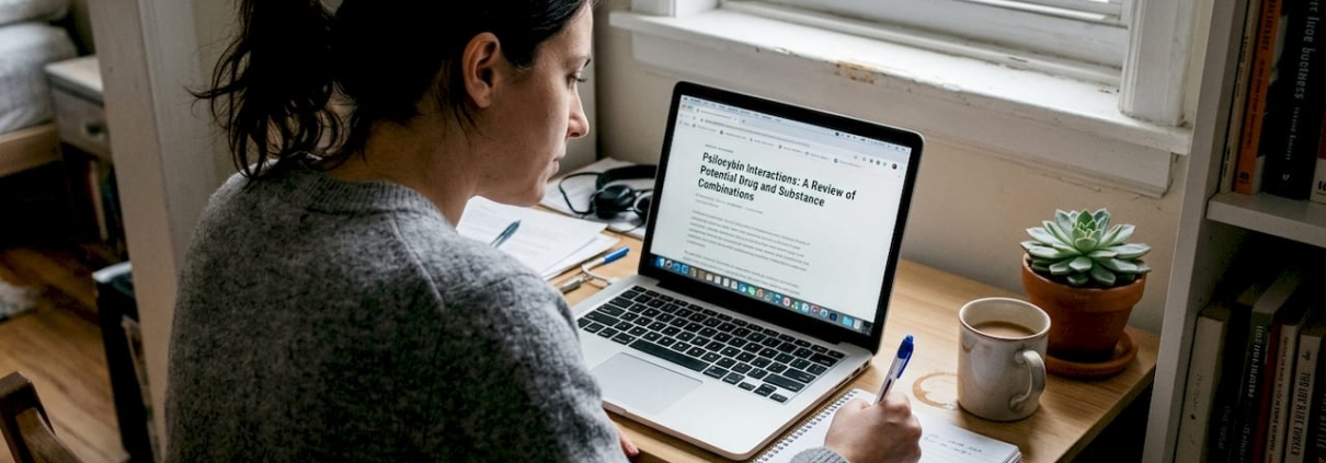 Woman researches psilocybin interactions at home desk