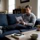 Man reading psilocybin pamphlet in Canadian living room