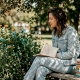Woman observing flowers in city park